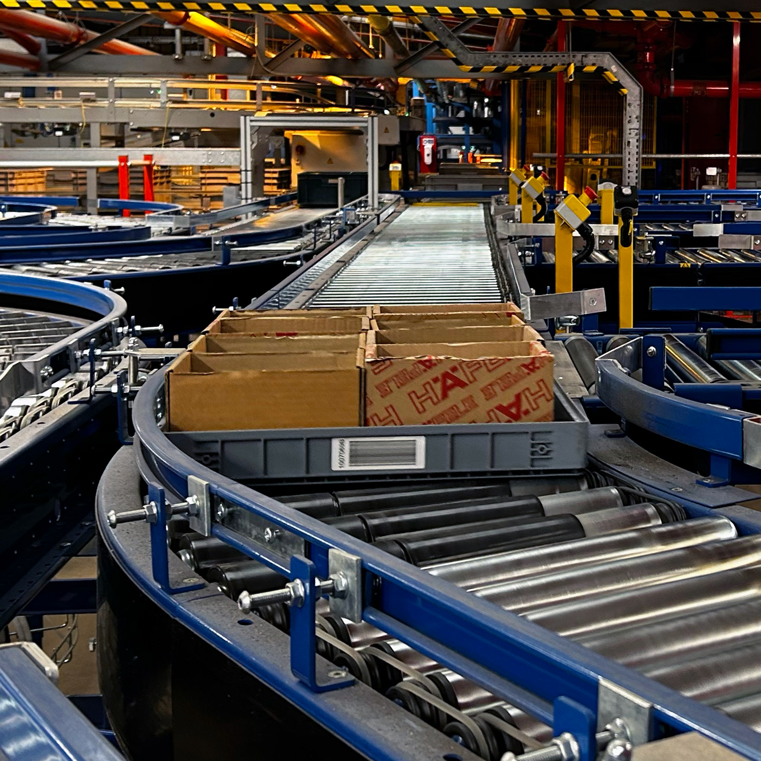 Loadhog automation tray in motion on a conveyor system, highlighting compatibility with automated handling and streamlined warehouse operations