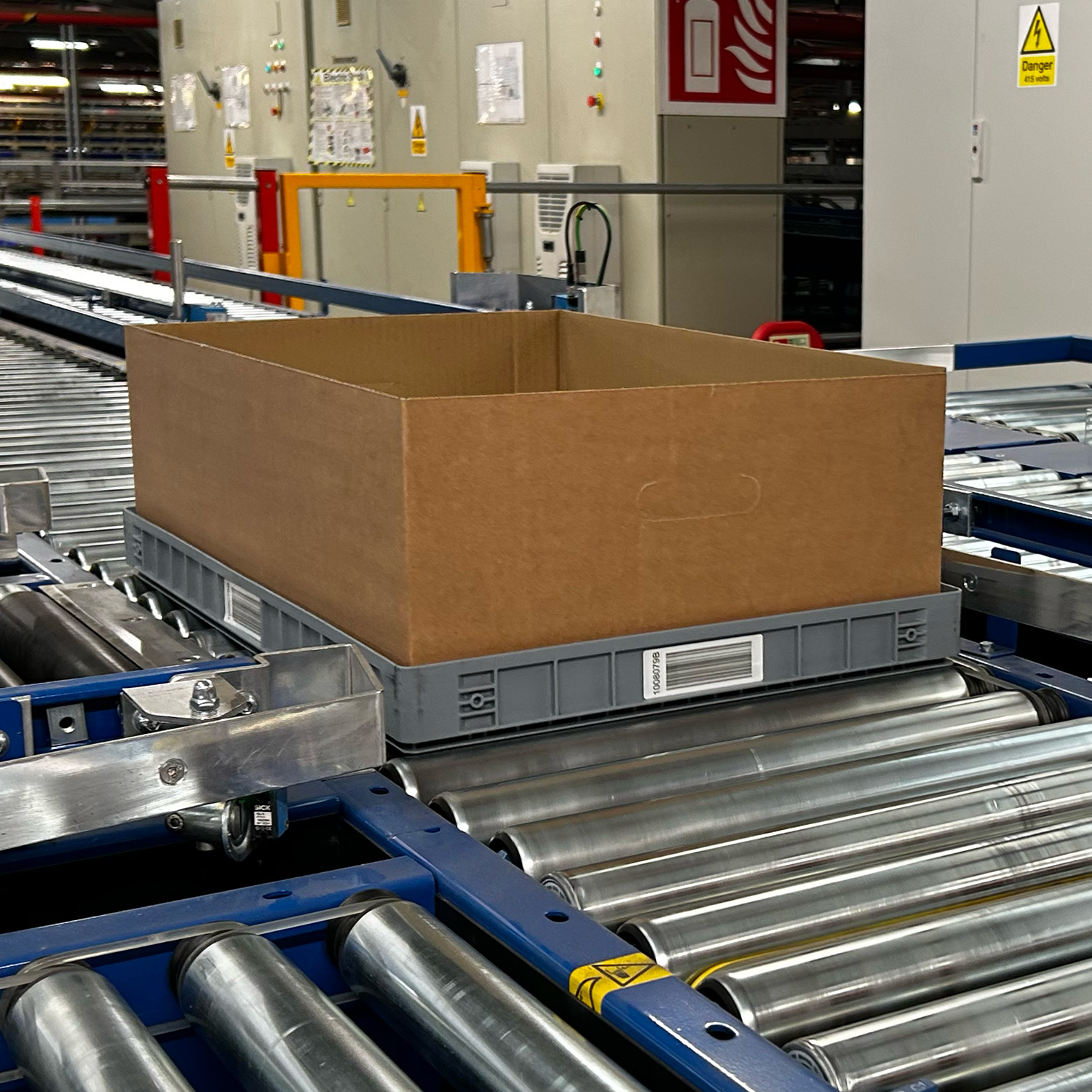 Loadhog automation tray in motion on a conveyor system, highlighting compatibility with automated handling and streamlined warehouse operations
